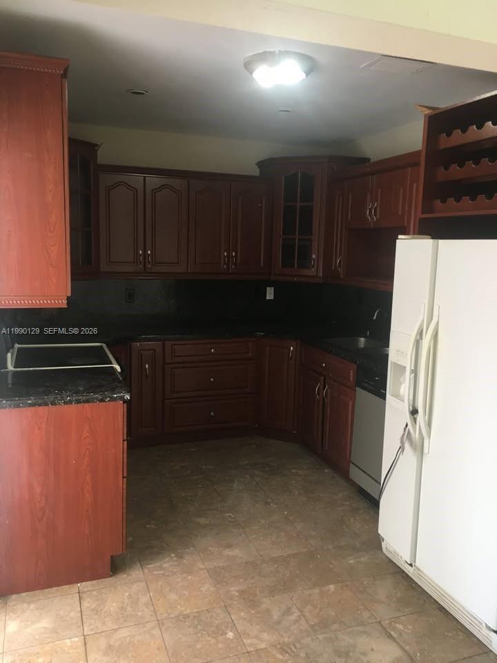 625 East 8th Court Hialeah, FL 33010 - Photo 11 of 18 a kitchen with a refrigerator and a stove