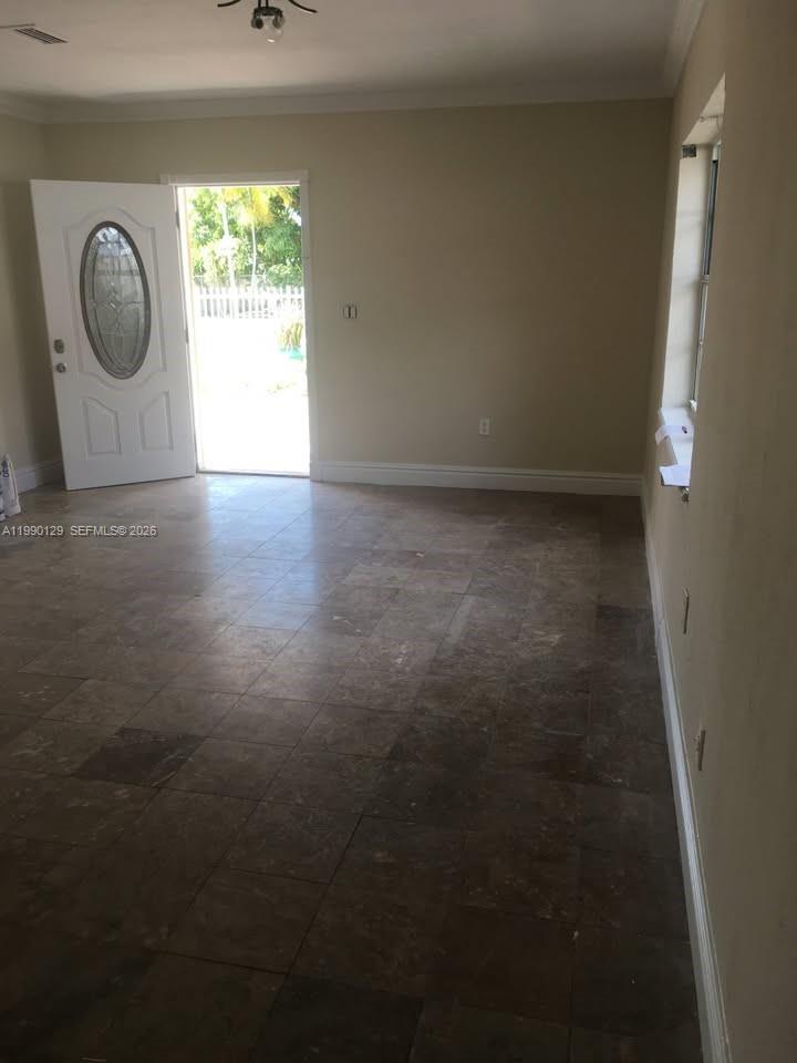 625 East 8th Court Hialeah, FL 33010 - Photo 3 of 18 a view of a livingroom with wooden floor and a window