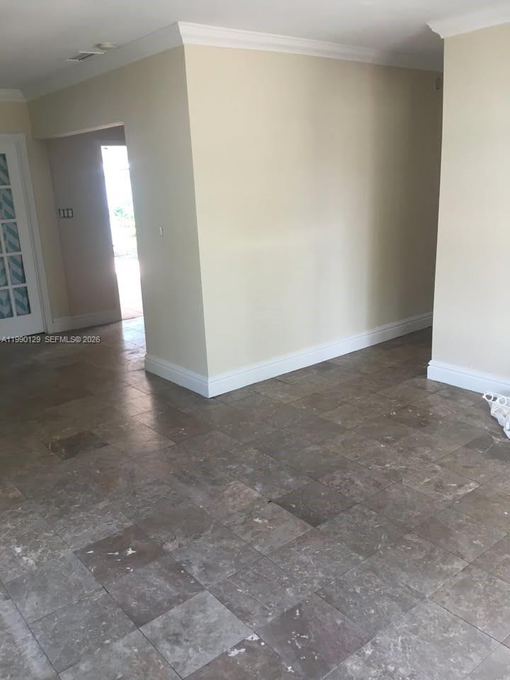 625 East 8th Court Hialeah, FL 33010 - Photo 5 of 18 an empty room with wooden floor and windows