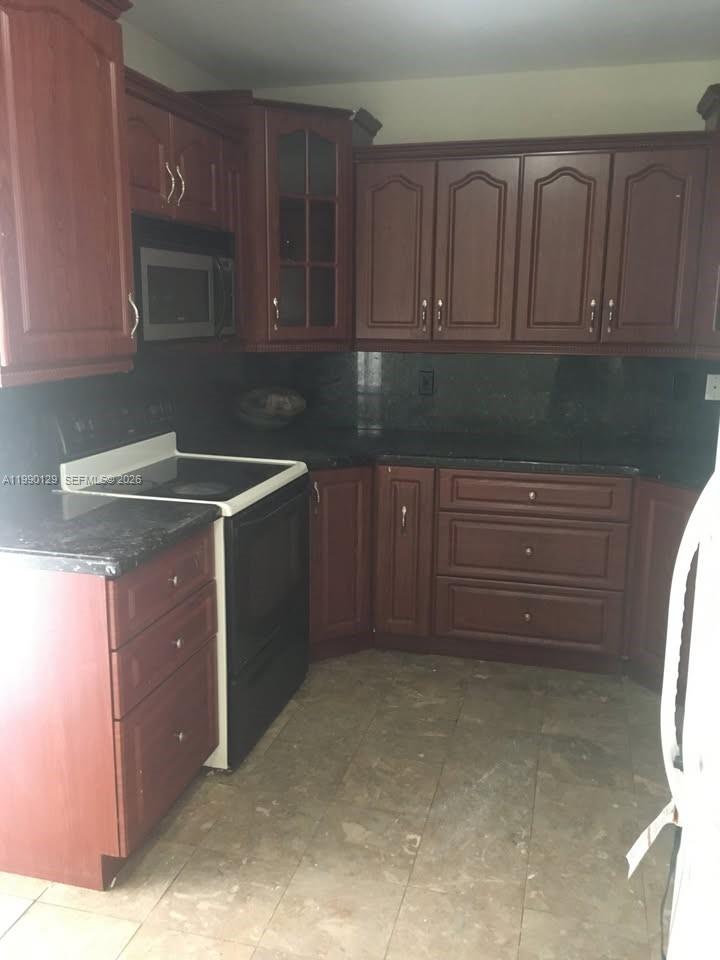 625 East 8th Court Hialeah, FL 33010 - Photo 10 of 18 a kitchen with a sink and cabinets