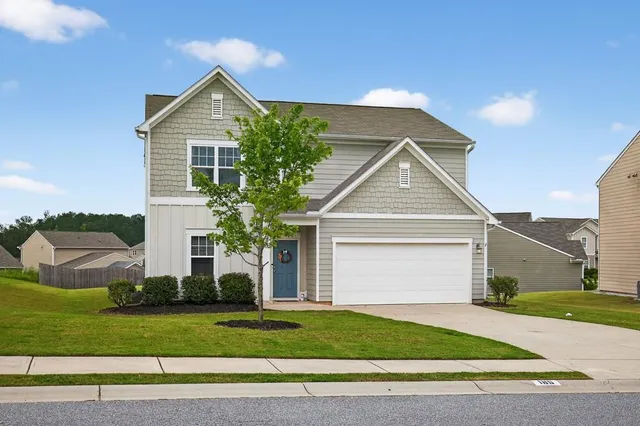a front view of a house with a yard and garage