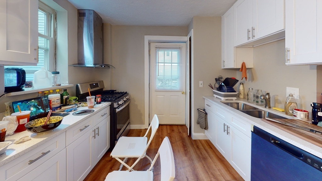 a kitchen with stainless steel appliances a sink a stove and cabinets