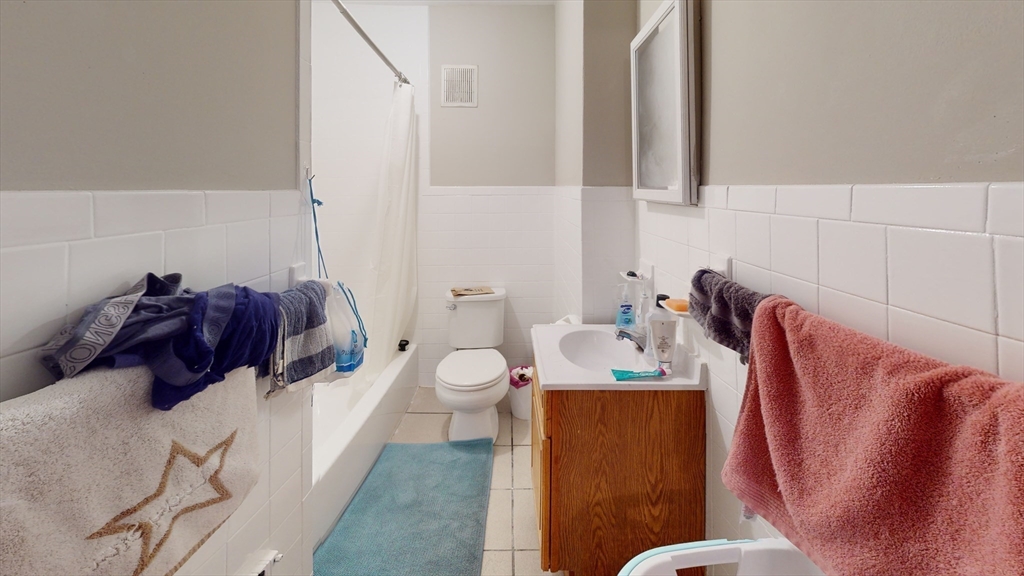 7 Winship Street, Unit 1 Boston, MA 02135 - Photo 5 of 6 a bathroom with a sink a toilet and a mirror