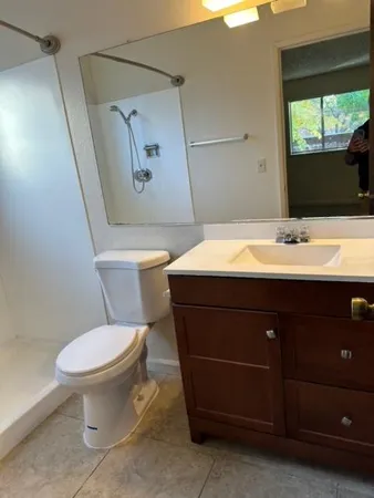 a bathroom with a sink toilet and mirror