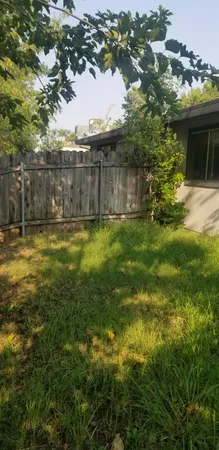 a swimming pool with outdoor seating and yard
