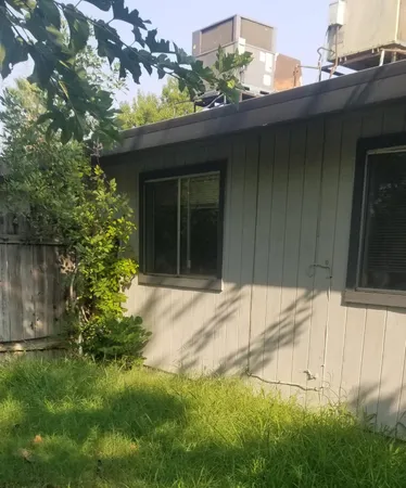 a view of a backyard with wooden fence