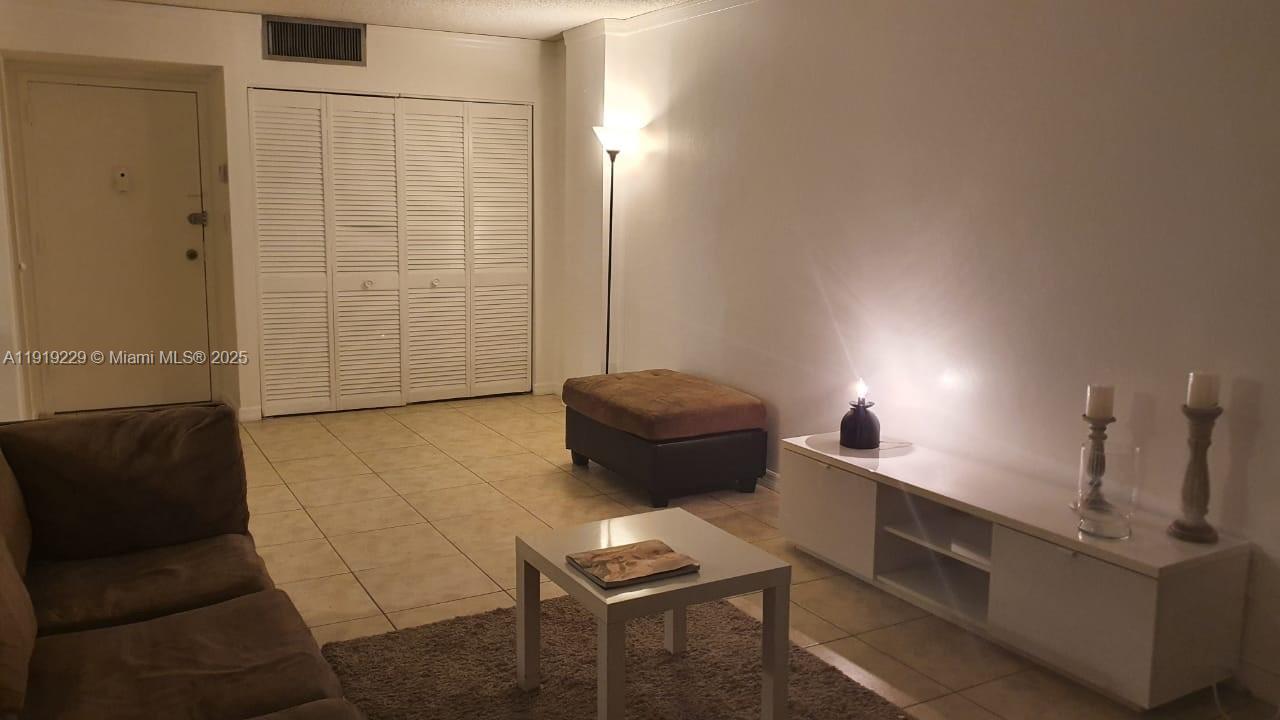 17021 North Bay Road, Unit 316 Sunny Isles Beach, FL 33160 - Photo 6 of 19 a living room with furniture and a rug