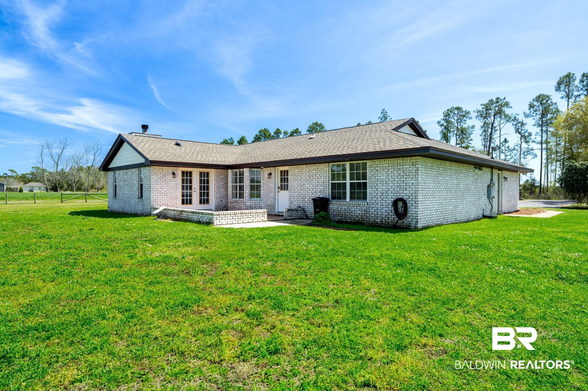 28475 Leiterman Road Elberta, AL 36530 - Photo 6 of 35 Rear view of house with french doors, brick siding, roof with shingles, and a lawn