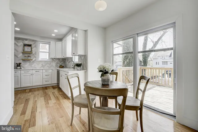 a kitchen with a table chairs sink and cabinets