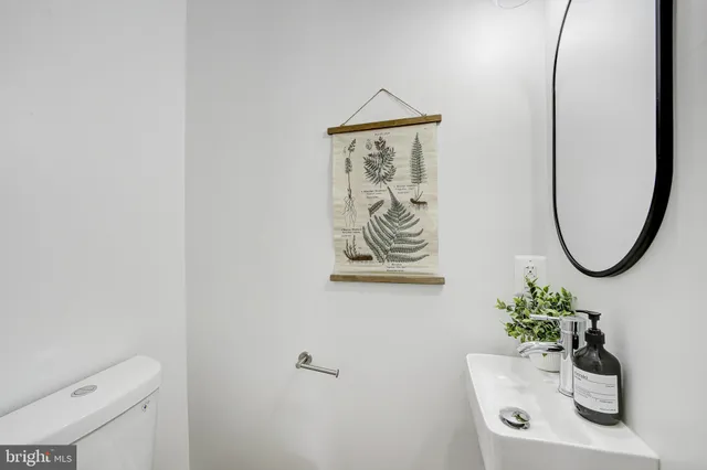 a bathroom with a toilet a sink and a mirror