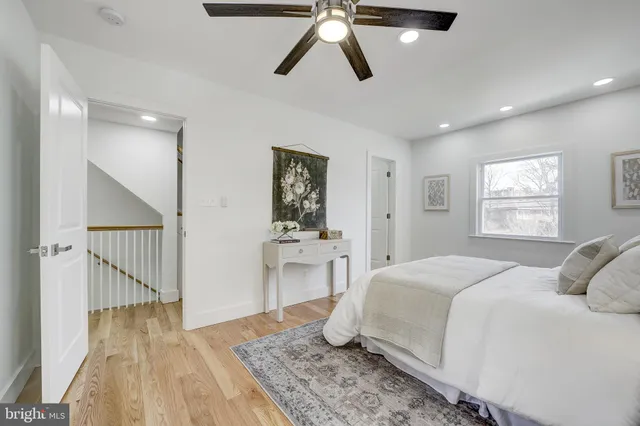 a bedroom with a large bed and a chandelier