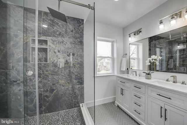 a bathroom with a shower sink and mirror