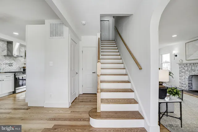 a view of entryway and hall with wooden floor