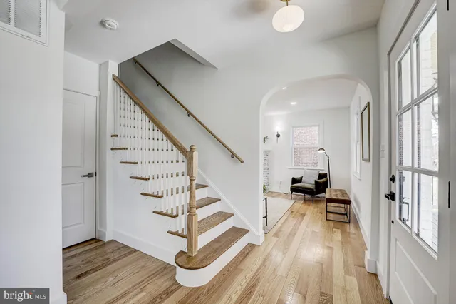 a view of entryway and hall with wooden floor