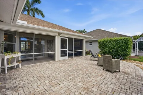 a view of a house with backyard and sitting area