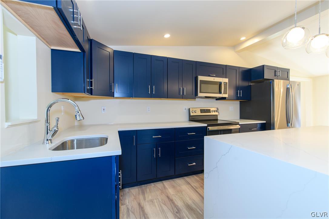 396 Swamp Road Wind Gap, PA 18091 - Photo 11 of 50 a kitchen with wooden cabinets and stainless steel appliances