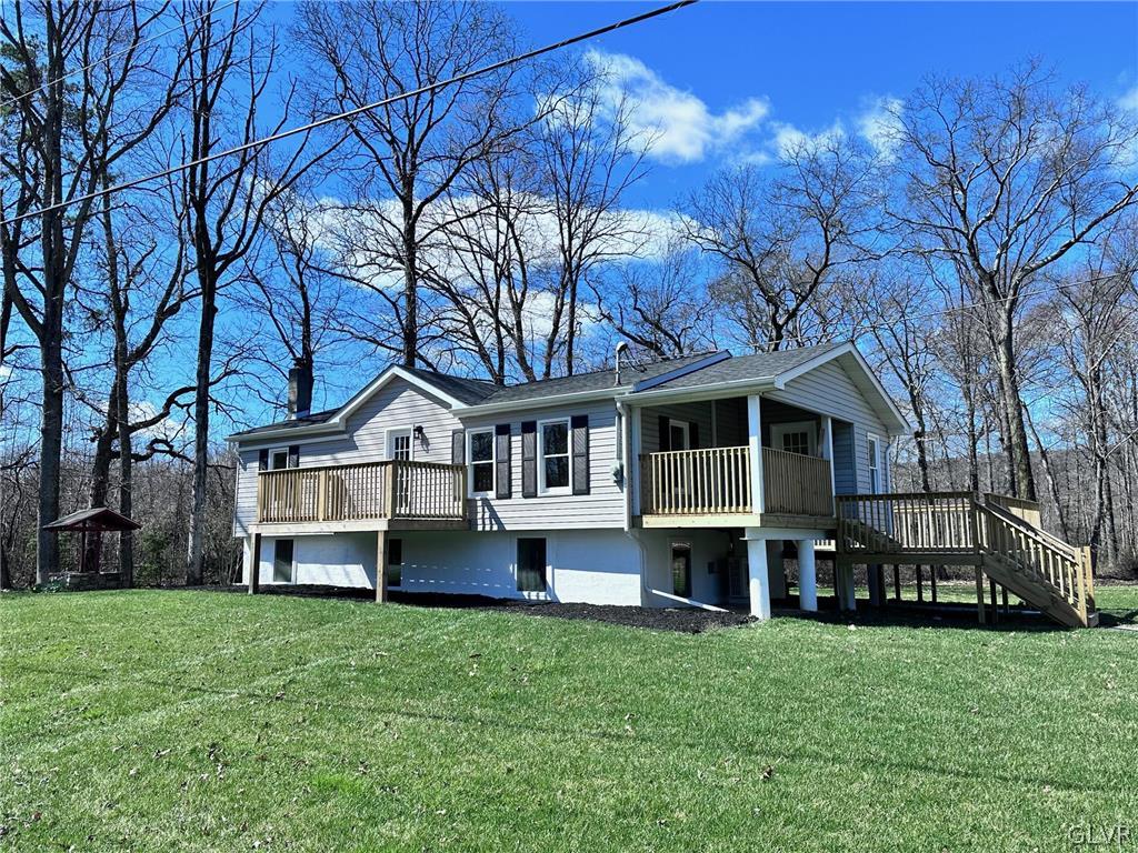 396 Swamp Road Wind Gap, PA 18091 - Photo 2 of 50 a front view of a house with a garden and trees