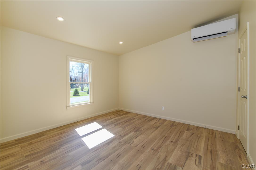 396 Swamp Road Wind Gap, PA 18091 - Photo 22 of 50 an empty room with wooden floor and windows