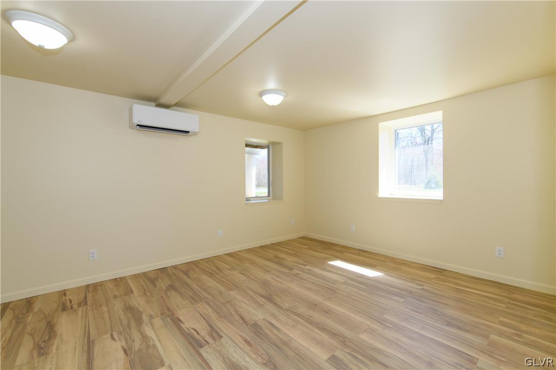 396 Swamp Road Wind Gap, PA 18091 - Photo 27 of 50 an empty room with wooden floor and windows