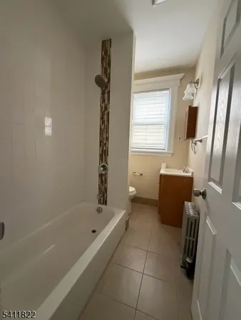 a bath room with a bath tub and a shower
