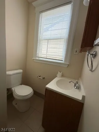 a bathroom with a sink toilet and a mirror