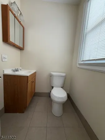 a bathroom with a sink toilet and mirror