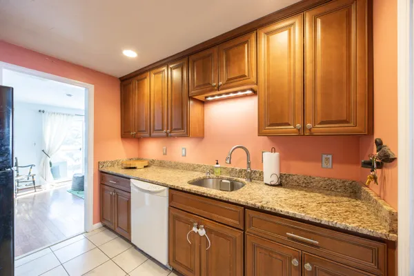 a kitchen with stainless steel appliances granite countertop a sink stove and cabinets