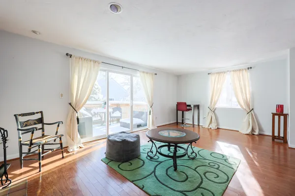 a living room with furniture a table and a large window
