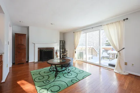 a living room with furniture fireplace and flat screen tv