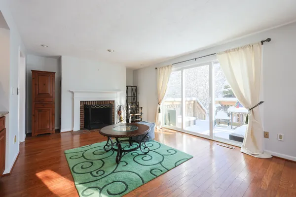 a living room with furniture a table and a fireplace