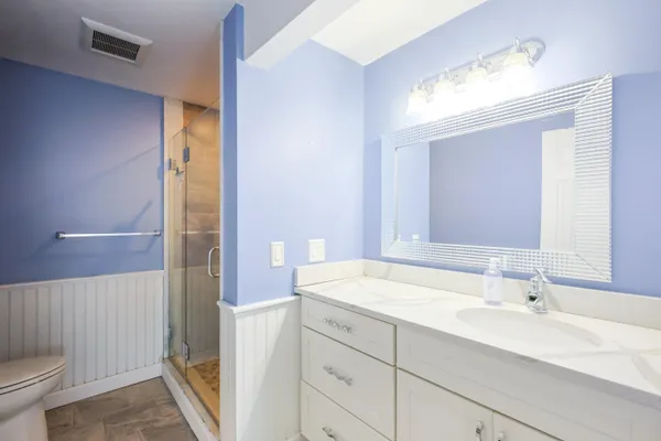 a bathroom with a sink toilet and shower