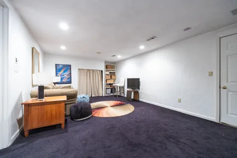 a view of a hallway with wooden floor and entryway