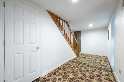 a view of a bedroom with wooden floor and a window