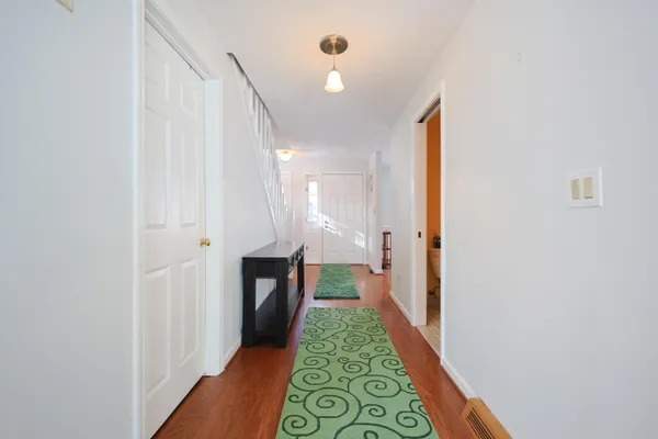 a view of a bedroom with wooden floor and a window