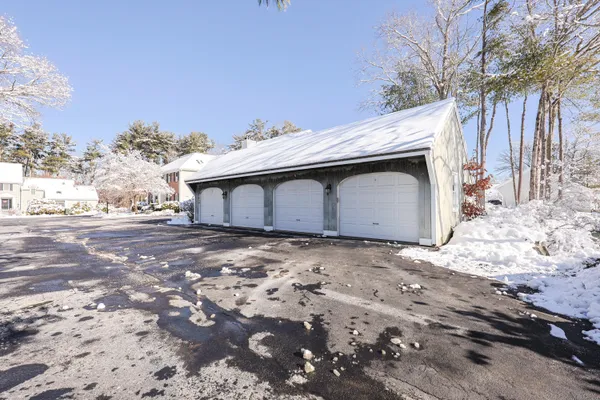 a view of a house with a yard covered in snow