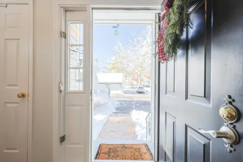 a dining room with furniture a chandelier and wooden floor