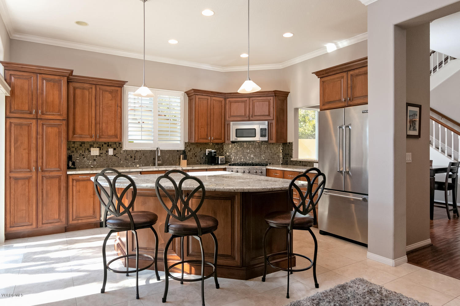 1121 Corte Riviera Camarillo, CA 93010 - Photo 3 of 35 a kitchen with stainless steel appliances granite countertop a table chairs refrigerator and sink