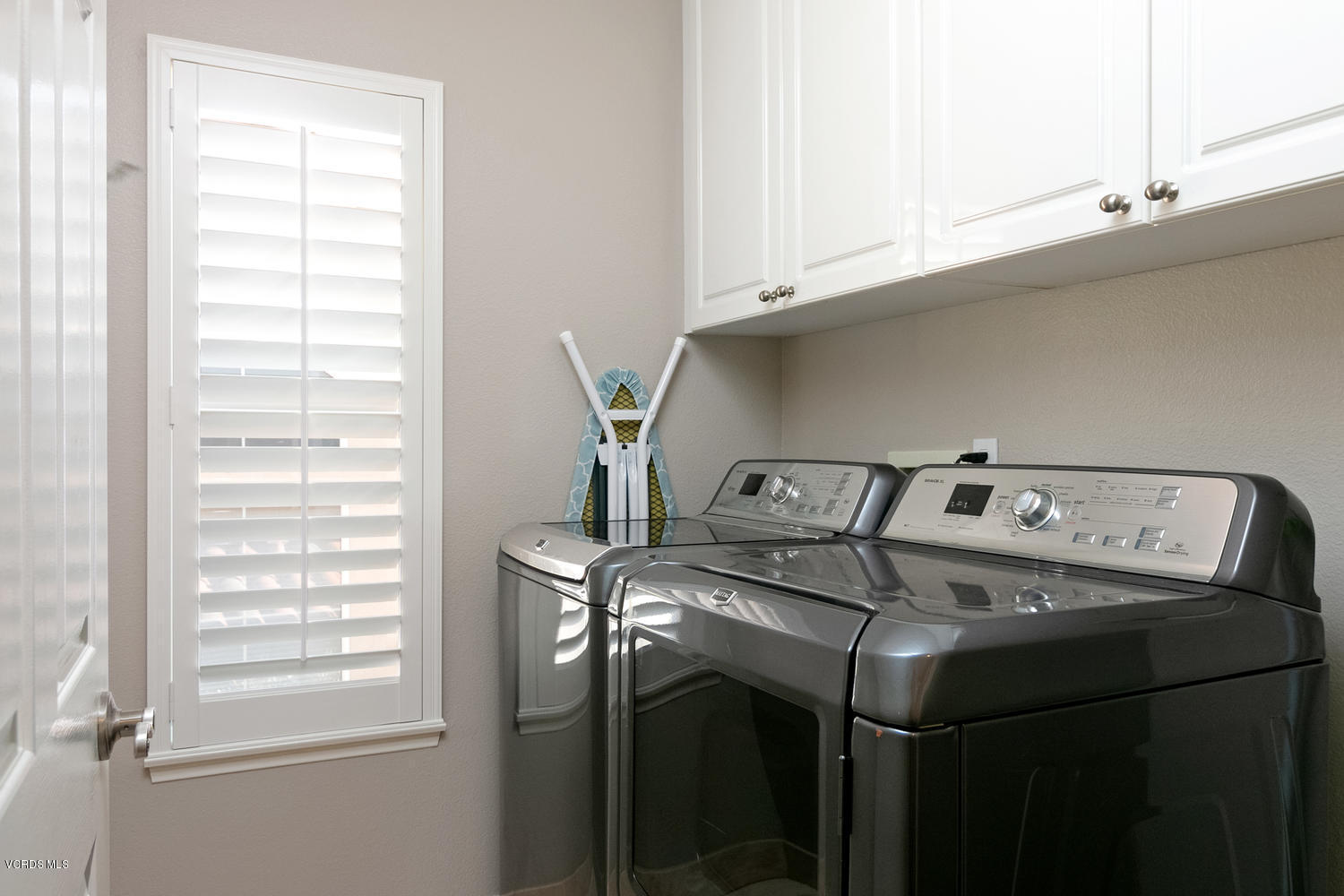 1121 Corte Riviera Camarillo, CA 93010 - Photo 28 of 35 a view of washer and dryer with kitchen in the background