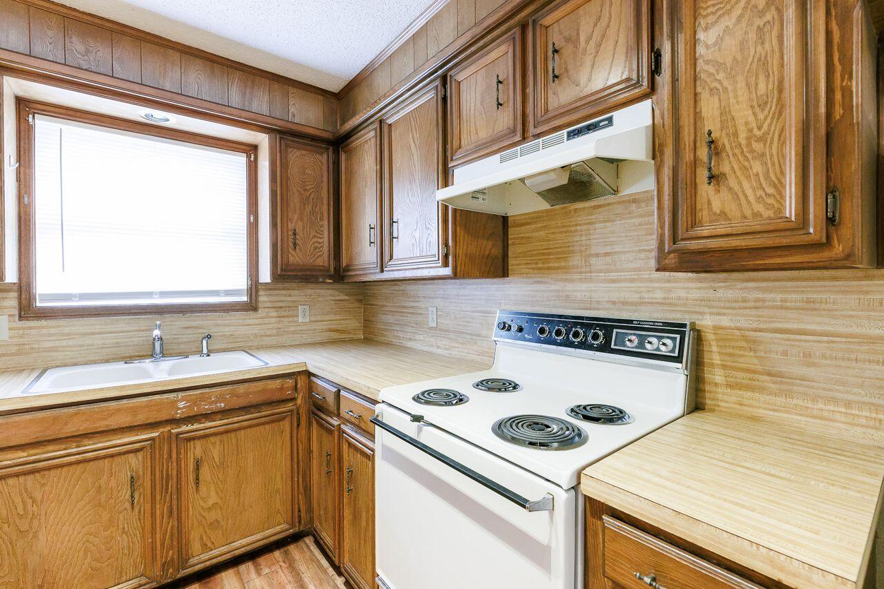 6411 York Drive, Unit B Lubbock, TX 79414 - Photo 13 of 28 a kitchen with a sink stove and cabinets