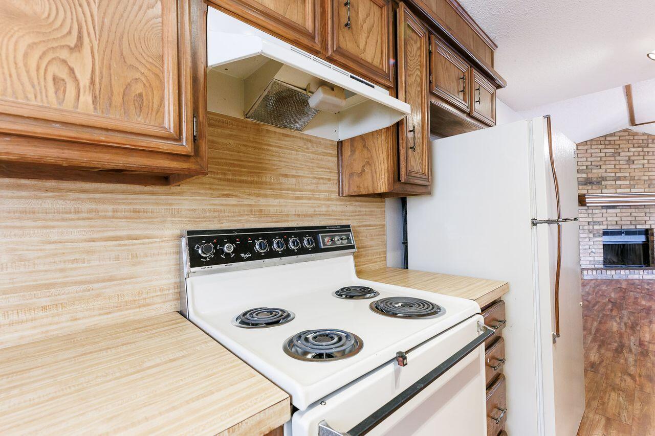6411 York Drive, Unit B Lubbock, TX 79414 - Photo 14 of 28 a kitchen with a stove and a refrigerator