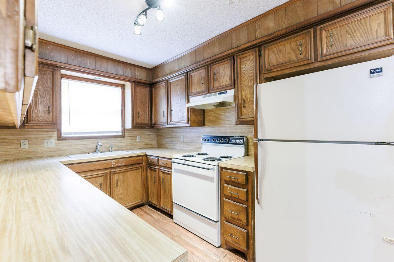 6411 York Drive, Unit B Lubbock, TX 79414 - Photo 16 of 28 a kitchen with stainless steel appliances granite countertop a sink a stove and a refrigerator