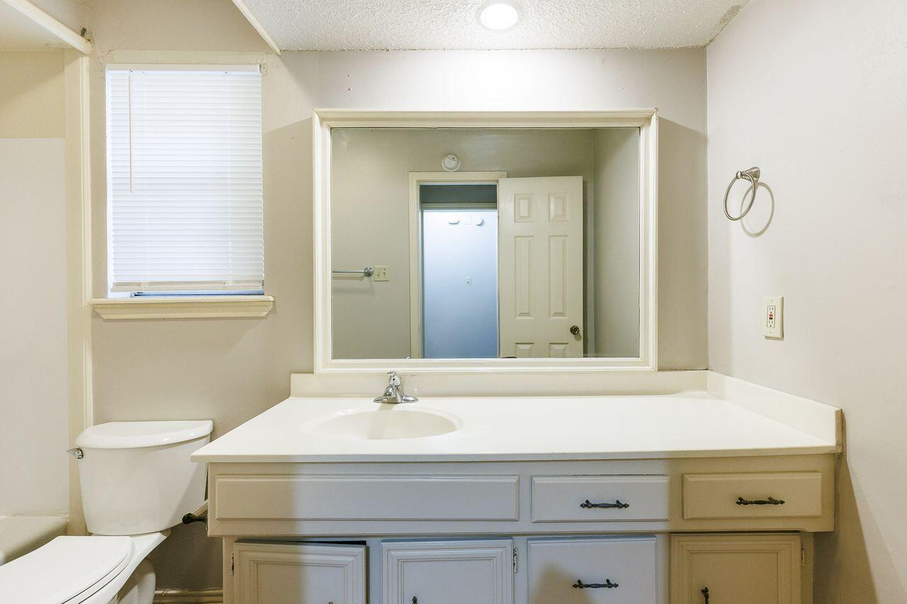 6411 York Drive, Unit B Lubbock, TX 79414 - Photo 21 of 28 a bathroom with a sink and a mirror