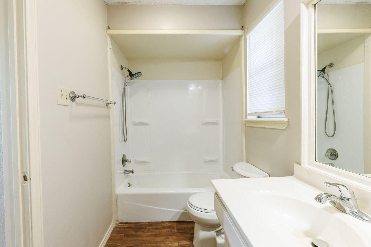 6411 York Drive, Unit B Lubbock, TX 79414 - Photo 23 of 28 a bathroom with a sink toilet and shower