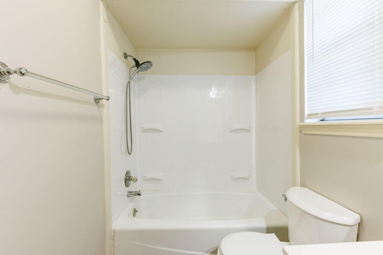 6411 York Drive, Unit B Lubbock, TX 79414 - Photo 24 of 28 a bathroom with a bathtub and a toilet