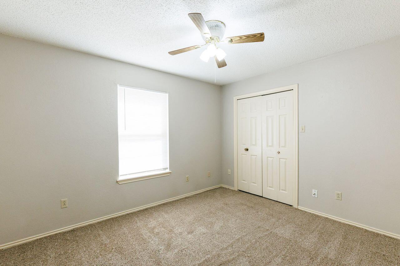 6411 York Drive, Unit B Lubbock, TX 79414 - Photo 26 of 28 an empty room with windows and fan
