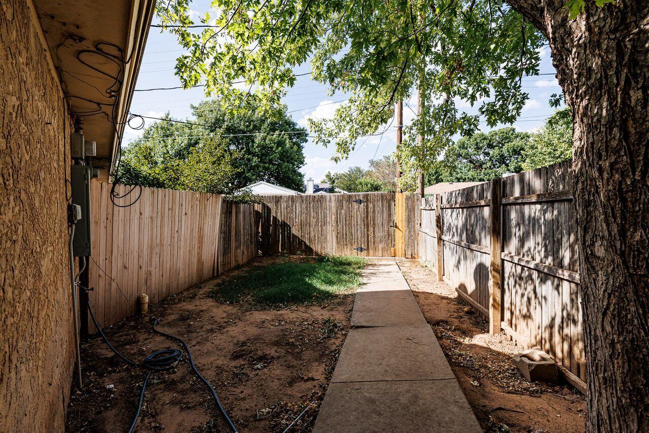 6411 York Drive, Unit B Lubbock, TX 79414 - Photo 27 of 28 a view of a pathway of a yard with wooden fence