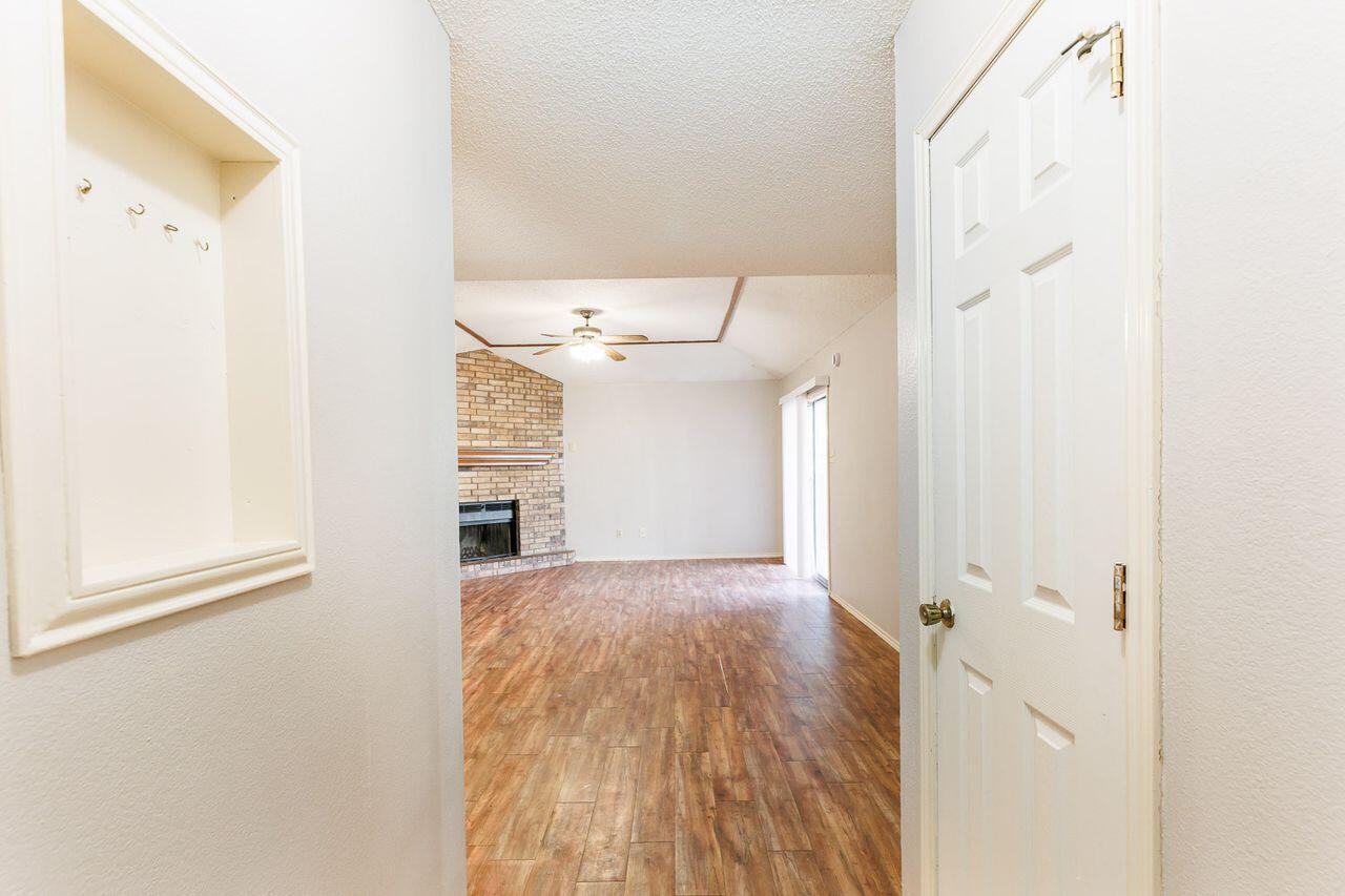 6411 York Drive, Unit B Lubbock, TX 79414 - Photo 4 of 28 a view of a hallway with wooden floor and entryway