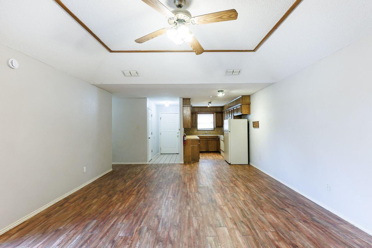 6411 York Drive, Unit B Lubbock, TX 79414 - Photo 8 of 28 a view of a livingroom with wooden floor