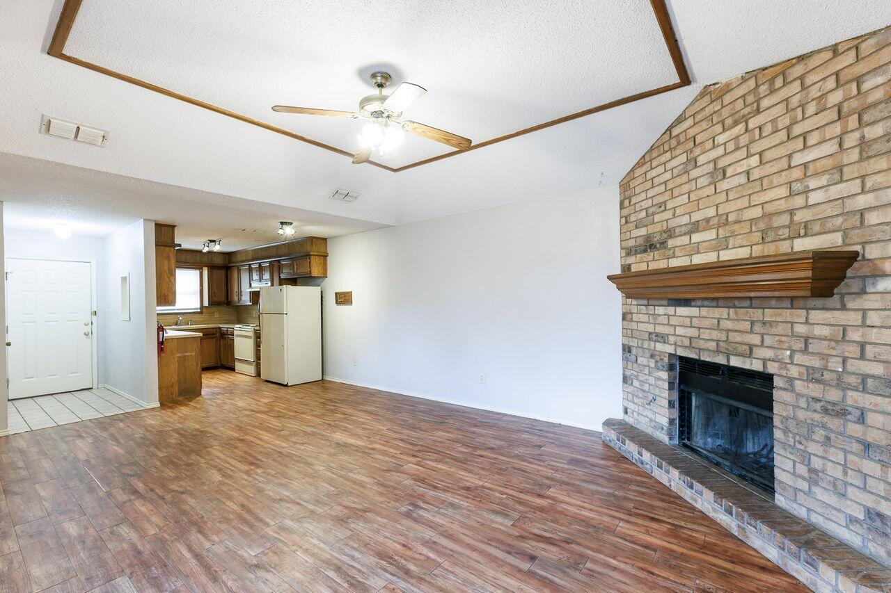 6411 York Drive, Unit B Lubbock, TX 79414 - Photo 9 of 28 a view of a kitchen with a stove cabinet and a fireplace