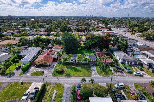 an aerial view of a houses with yard